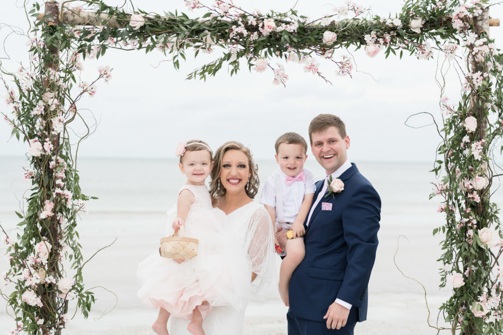 charlotte wedding photographers destination wedding in tampa florida family portraits on beach rustic arch