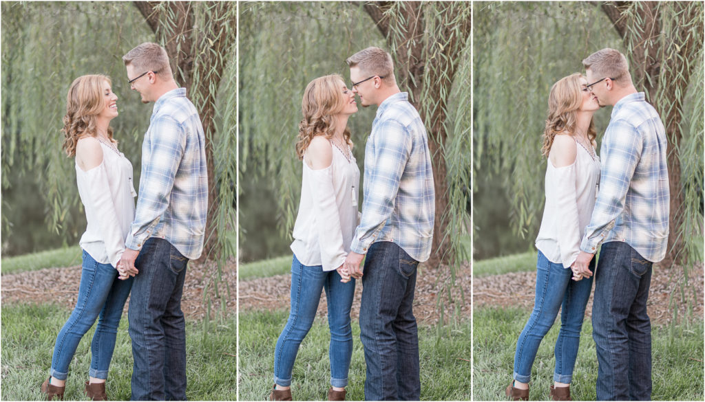 charlotte engagement photography shot of couple kissing under willow tree in charlotte, nc