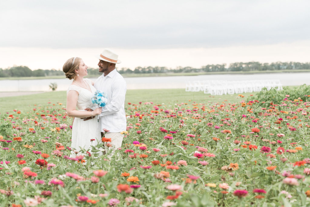 charleston wedding photographer shot of bride and groom in flower field