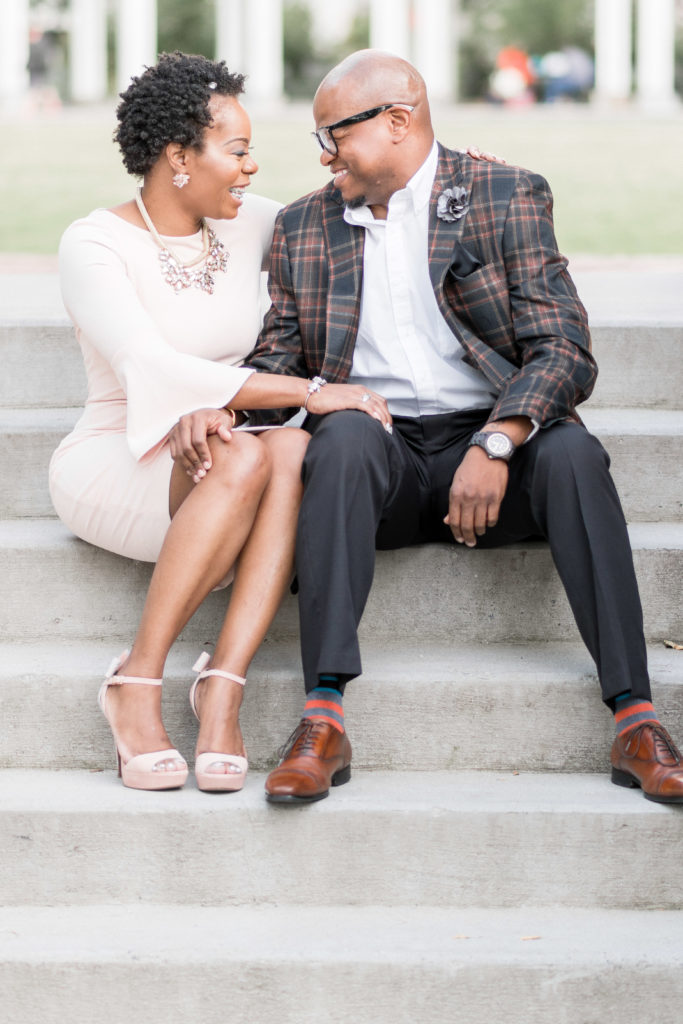 engagement photographer in charlotte capturing couple in romare bearden park laughing on stairs