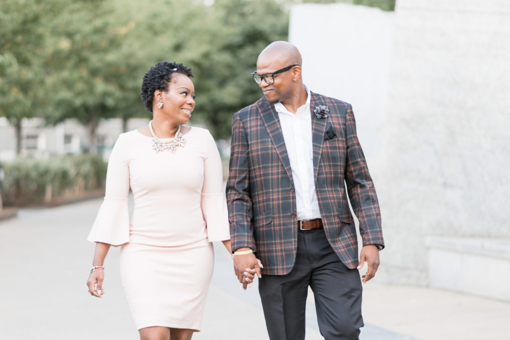 engagement photographer in charlotte capturing couple in romare bearden park in uptown walking