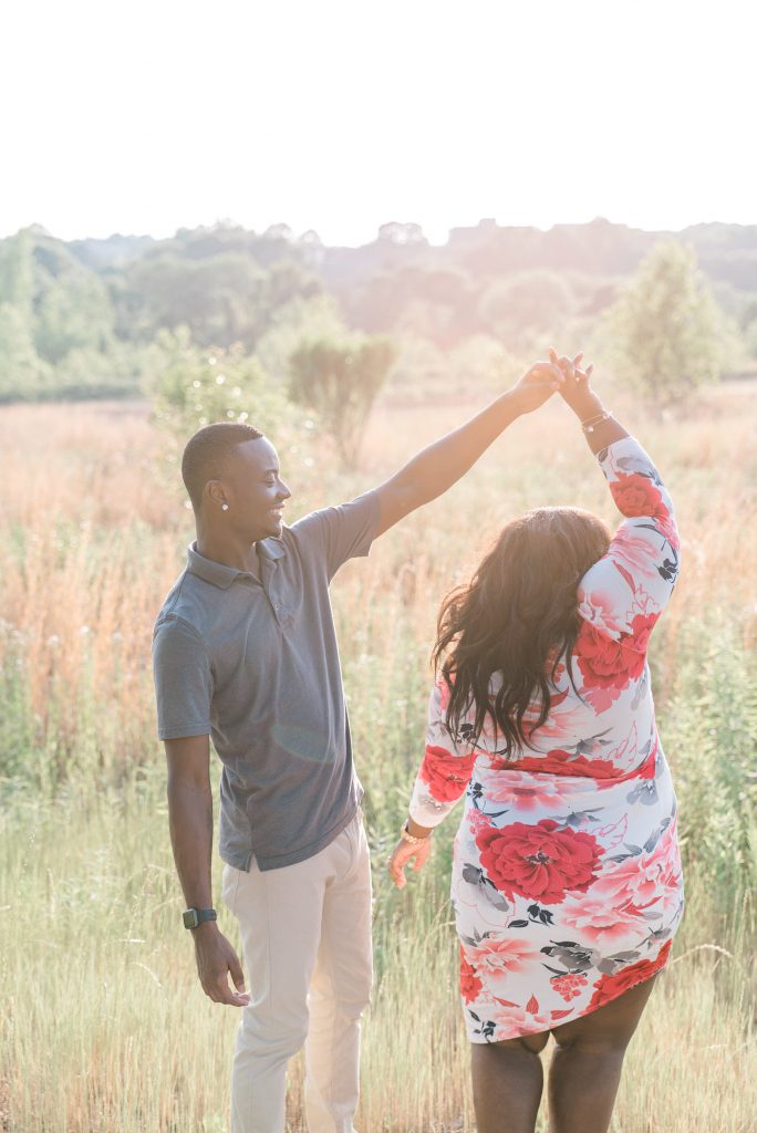 Charlotte NC Engagement Photographer couple in south charlotte field sunset golden hour dancing uptown charlotte