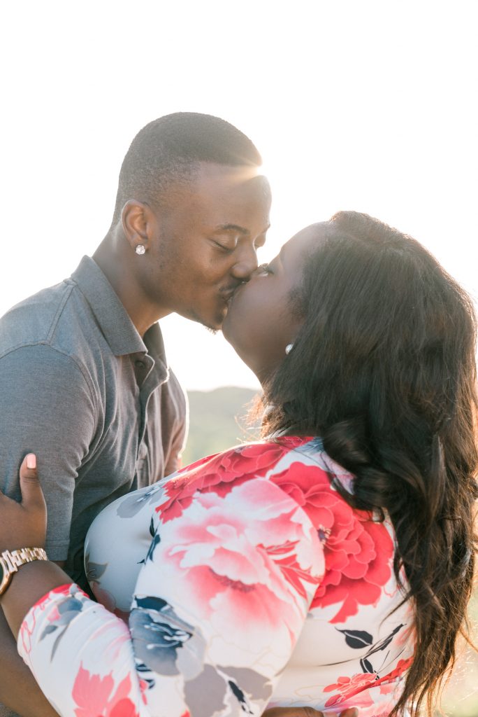 Charlotte NC Engagement Photographer couple in south charlotte field sunset golden hour dancing uptown charlotte kissing