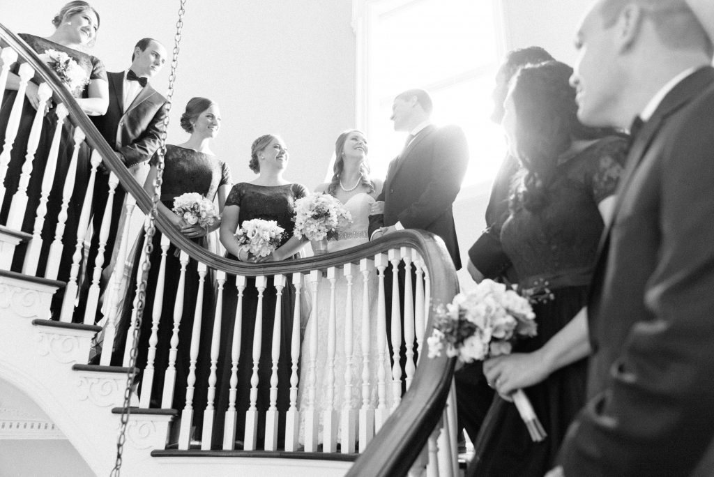 Wedding Photographer in Charlotte NC South Park Forrest Hill Church groomsmen and bridesmaids on staircase with bride and groom