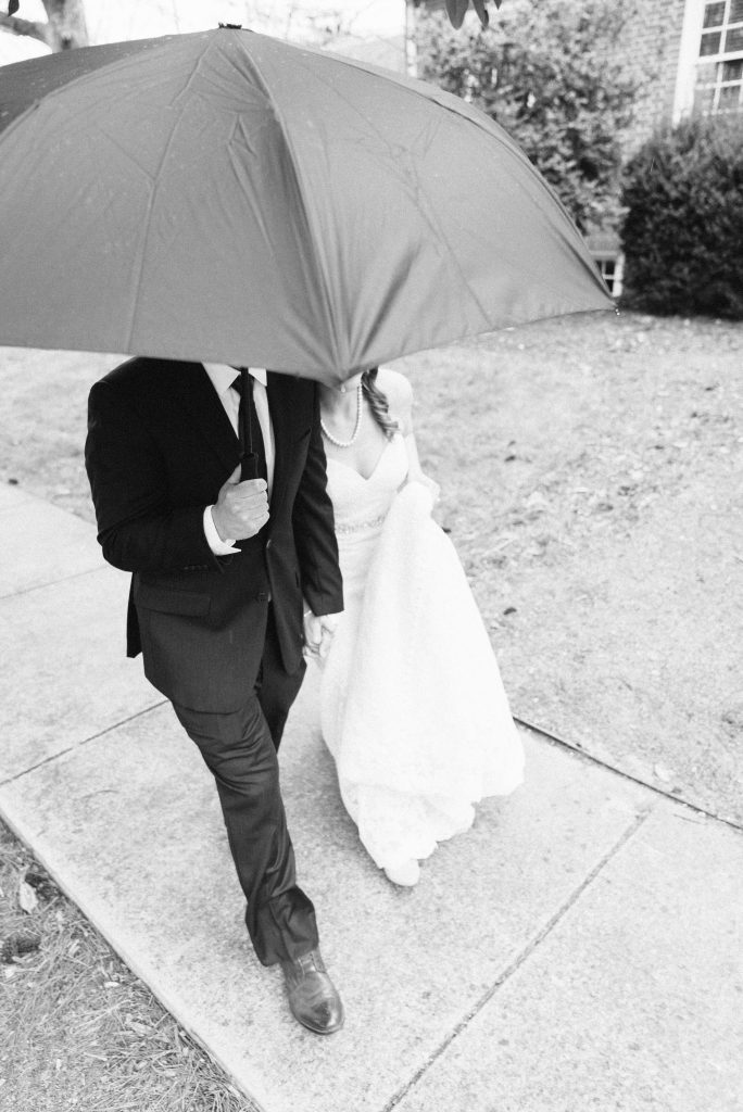 Wedding Photographer in Charlotte NC South Park Forrest Hill Church fine art black and white shot of bride and groom under umbrella