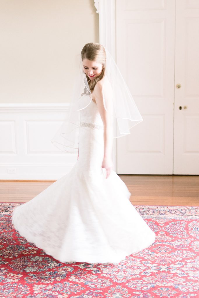 Wedding Photographer in Charlotte NC South Park Forrest Hill Church bride twirls white dress on red carpet