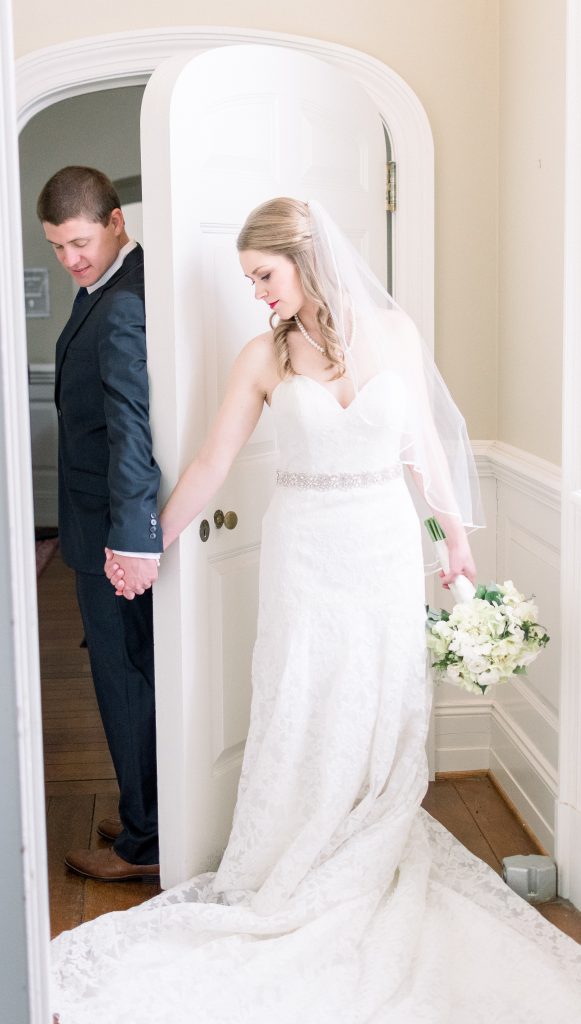 Wedding Photographer in Charlotte NC South Park Forrest Hill Church bride and groom first touch in arch doorway
