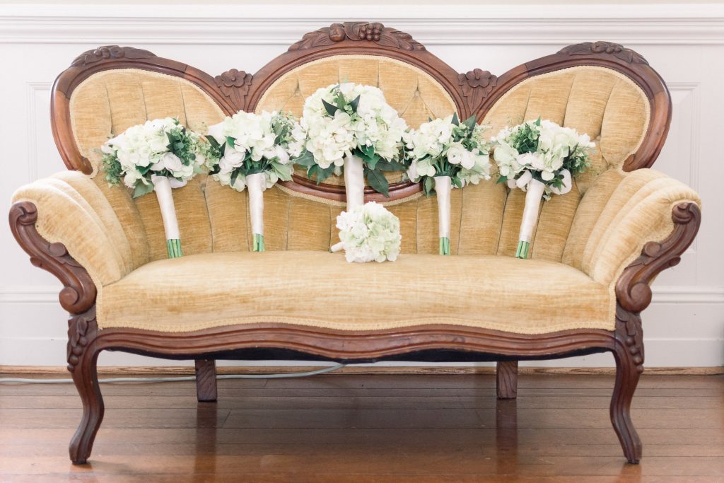 Wedding Photographer in Charlotte NC South Park Forrest Hill Church silk white hydrangea bouquets on antique yellow couch