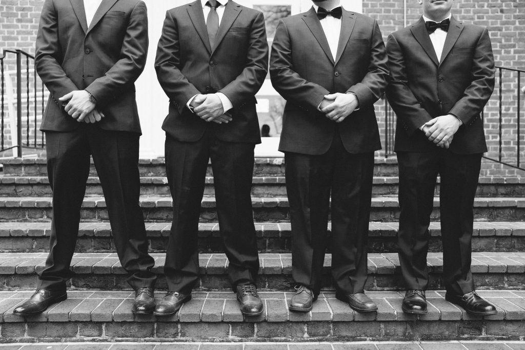 Wedding Photographer in Charlotte NC South Park Forrest Hill Church fine art shot of four groomsmen on brick stairs