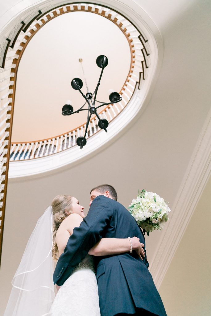Wedding Photographer in Charlotte NC South Park Forrest Hill Church bride and groom first look under spiral staircase