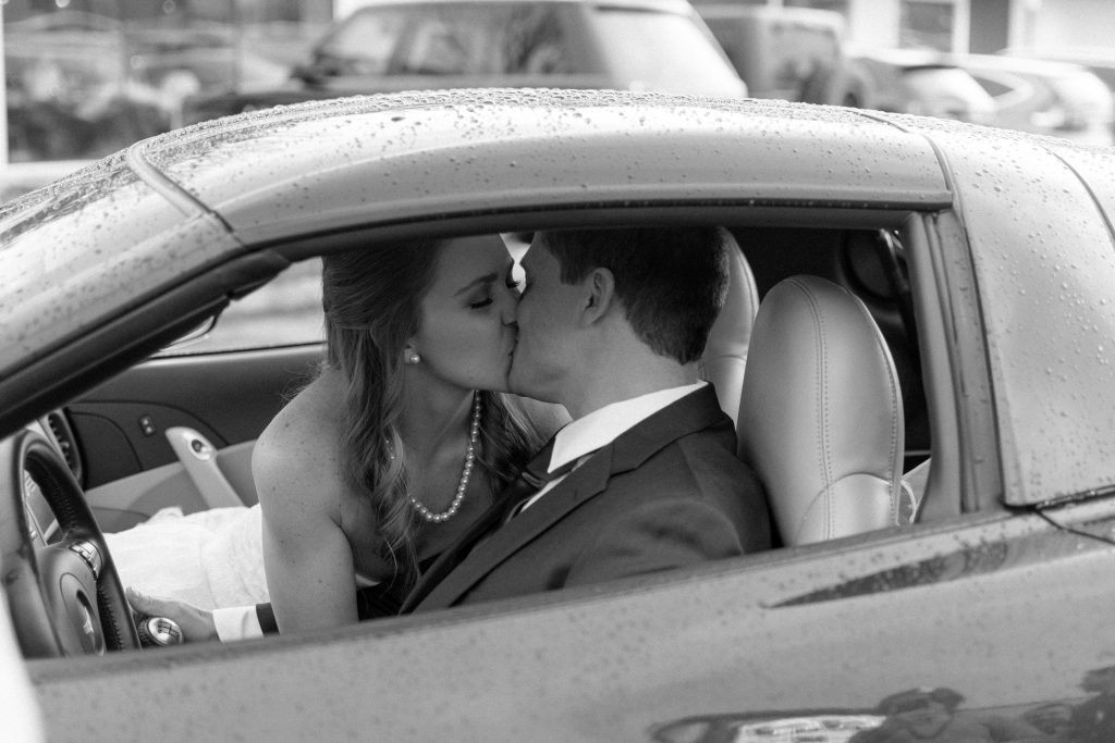 Wedding Photographer in Charlotte NC South Park Forrest Hill Church black and white of the bride and groom kiss is corvette