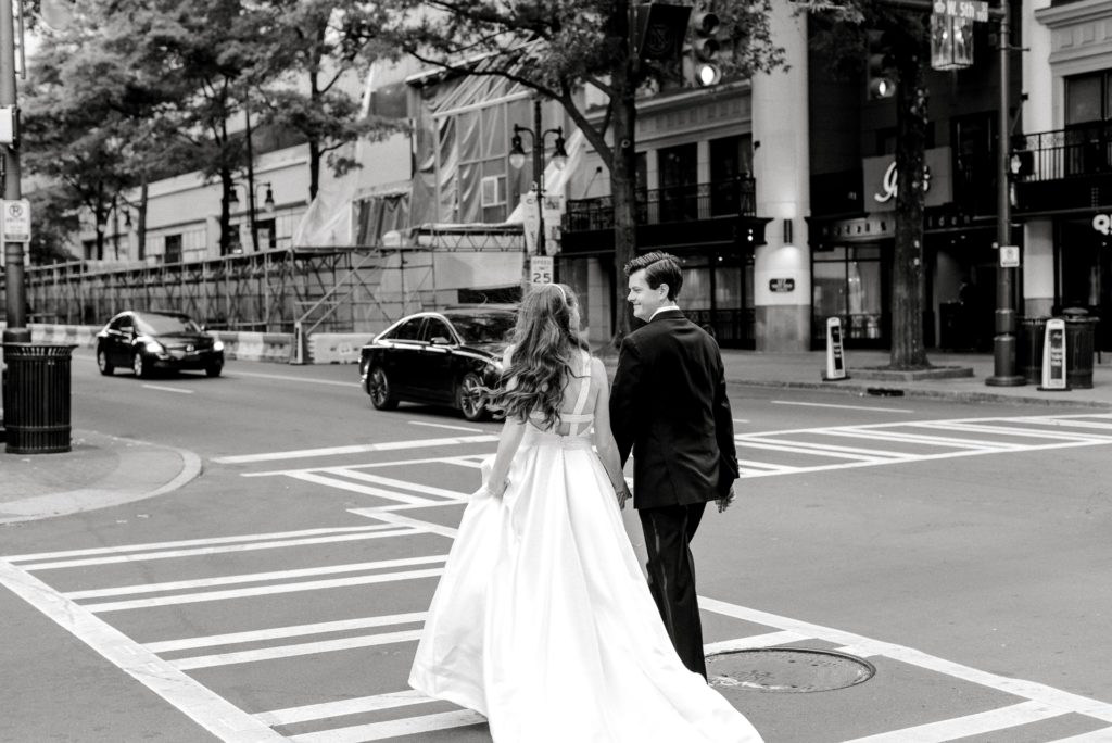 bride and groom walking in Uptown Charlotte