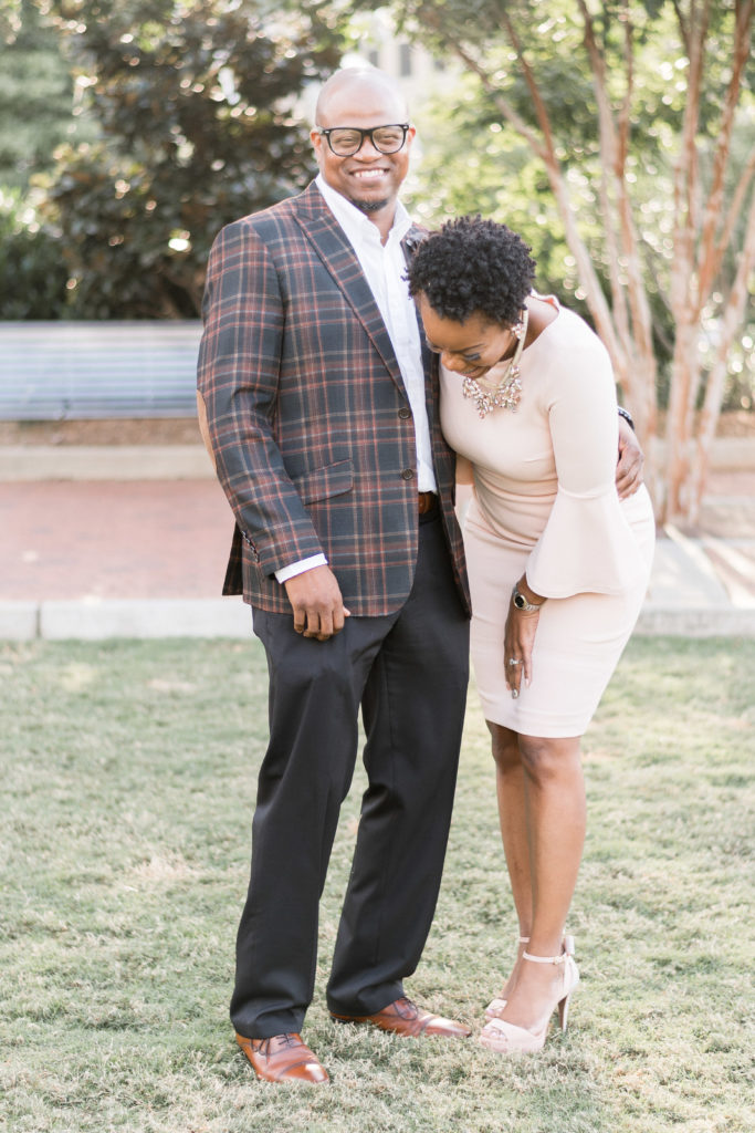 engagement photographer in charlotte capturing couple in romare bearden park laughing 