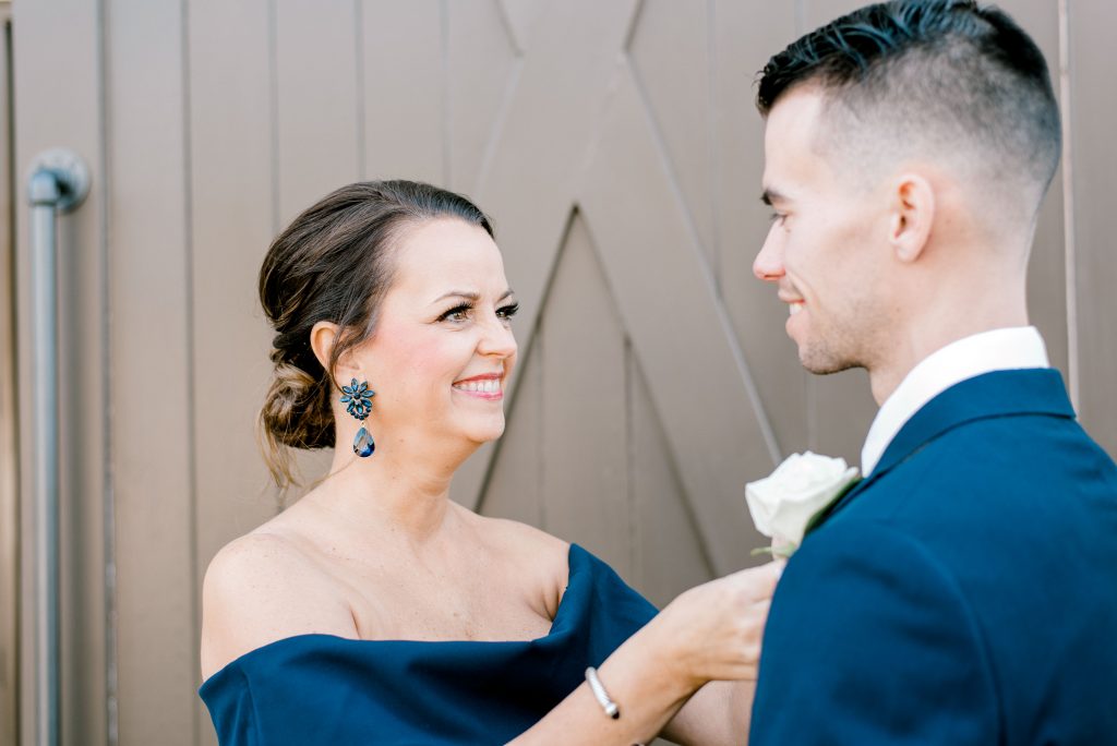 mother and son putting boutonniere