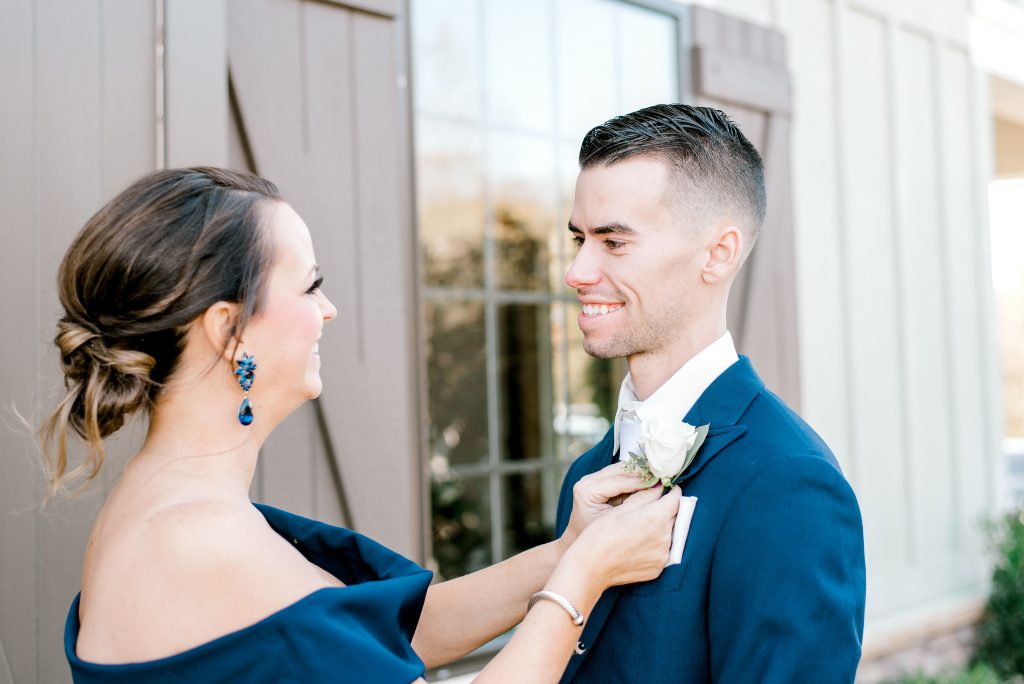 mother and son putting boutonniere