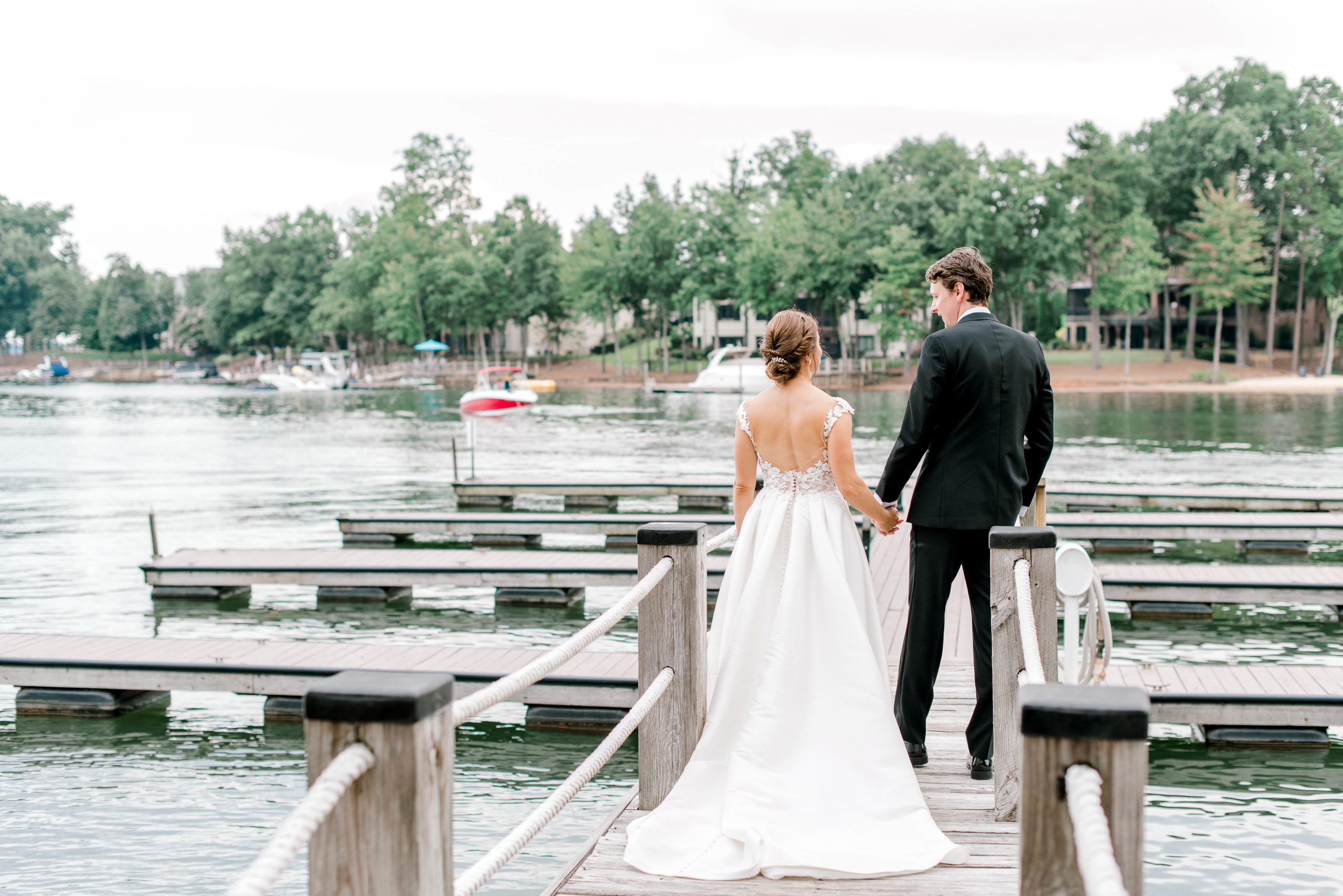 bride and groom walking along dock